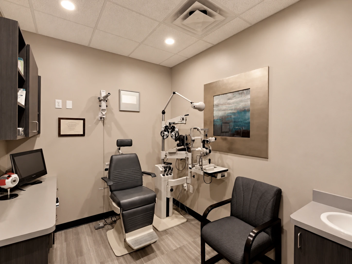 A private examination room at Tatum Eyecare with the exam chair and ophthalmic instruments ready for a patient