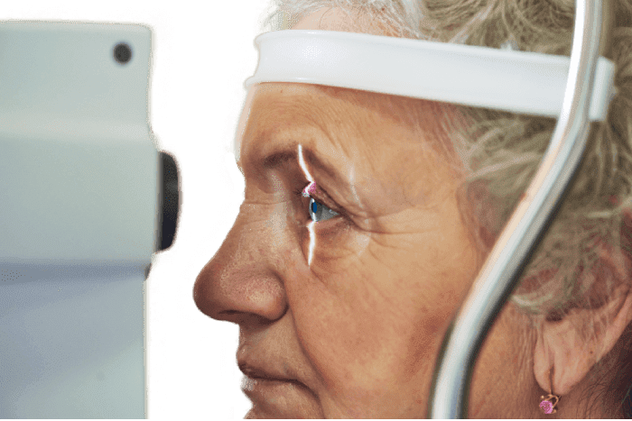 an elderly woman getting an eye exam